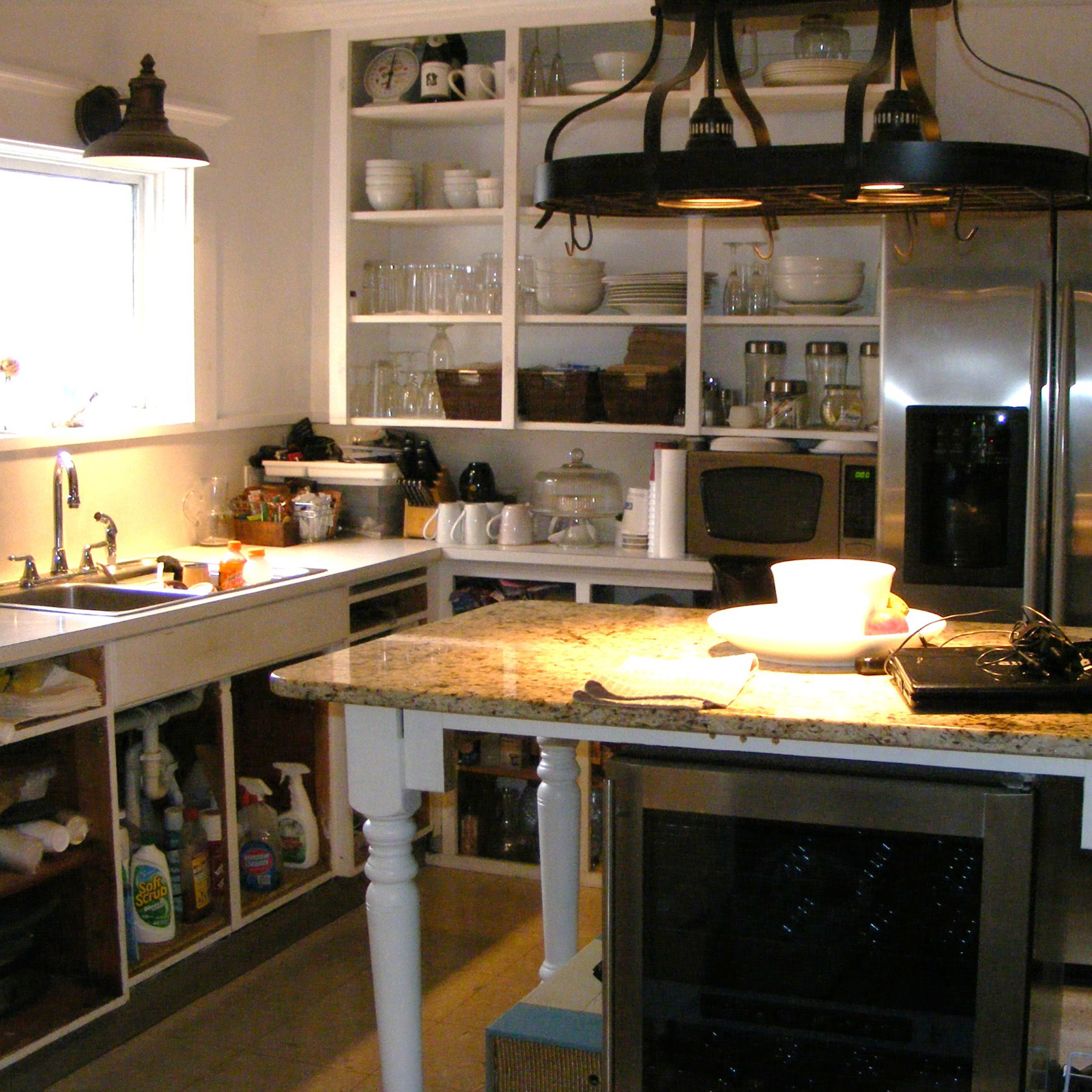 Entry 16 - Missing cabinet doors make this kitchen look messy and disorganized