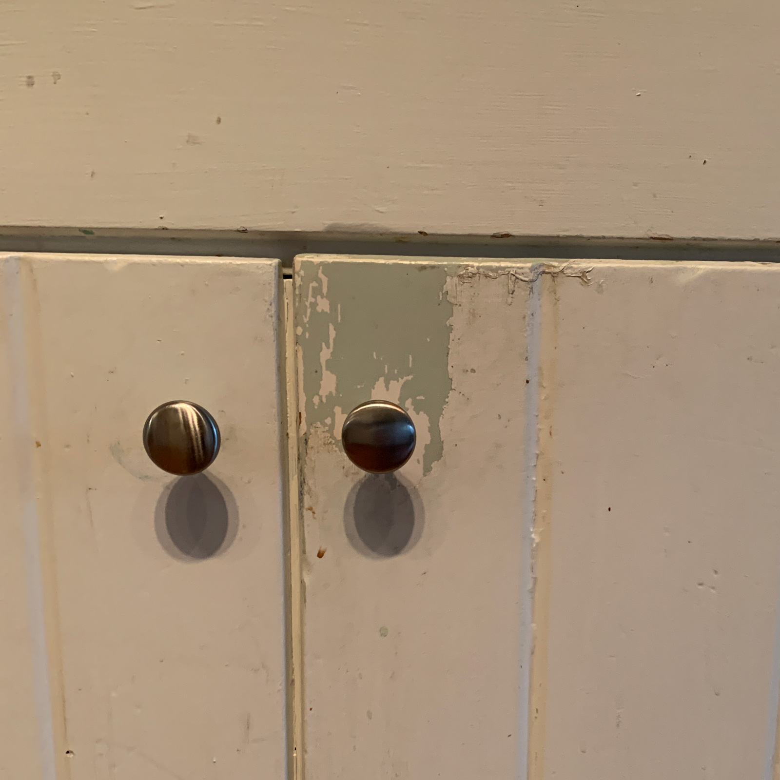 Entry - These old painted cabinets are in desperate need of replacement